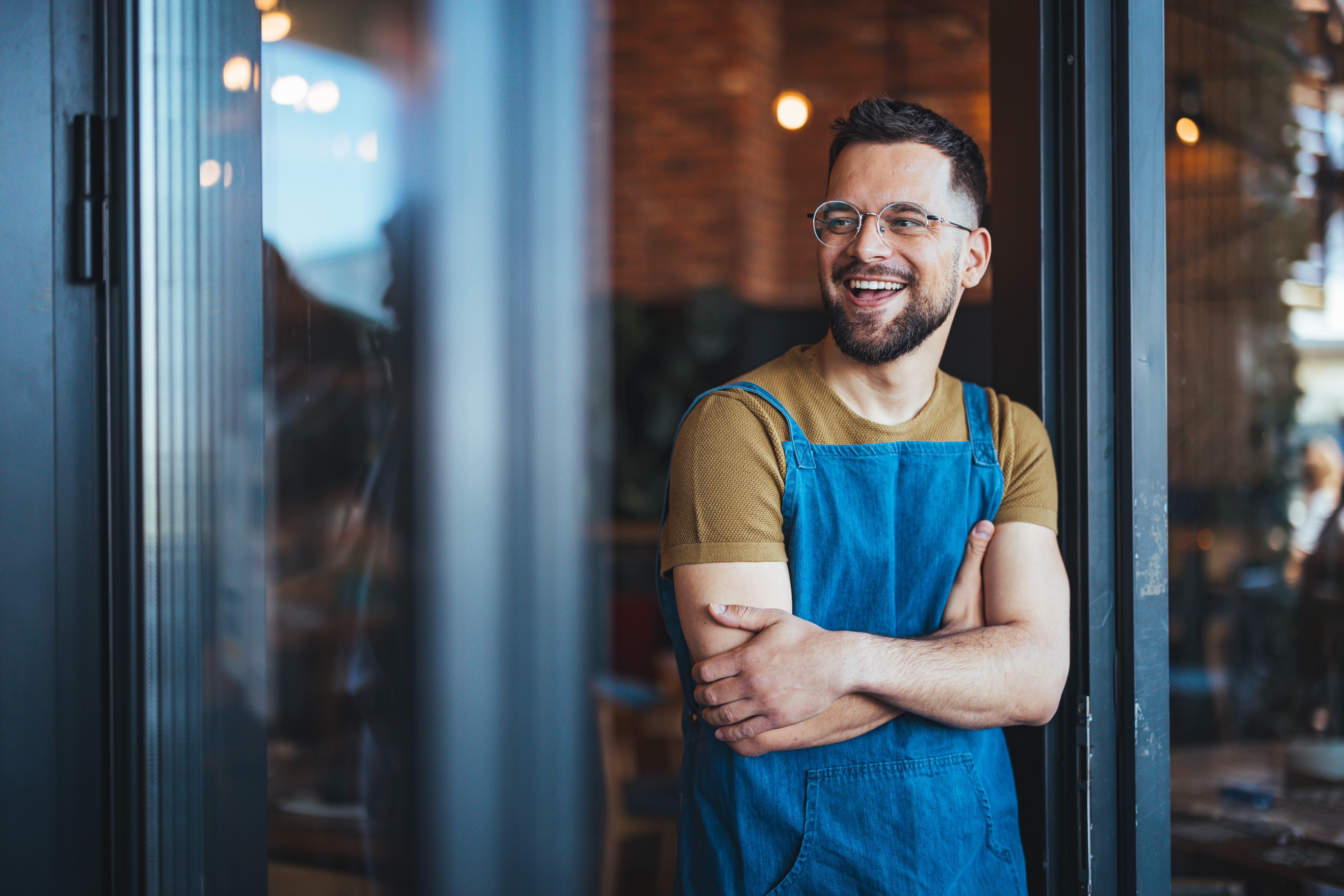 Small business owner standing in a shop doorway